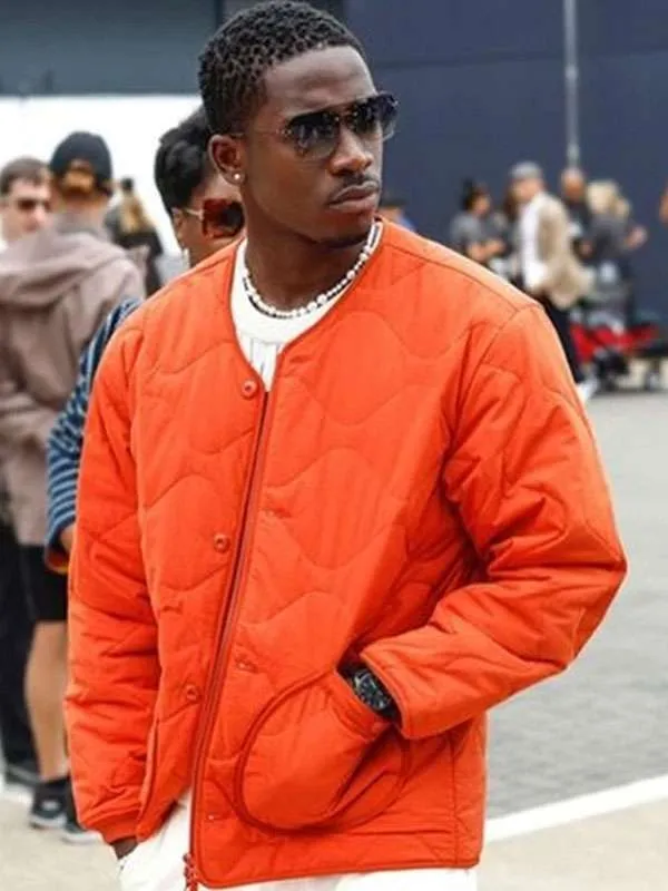 Damson idris f1 the movie orange jacket front view
